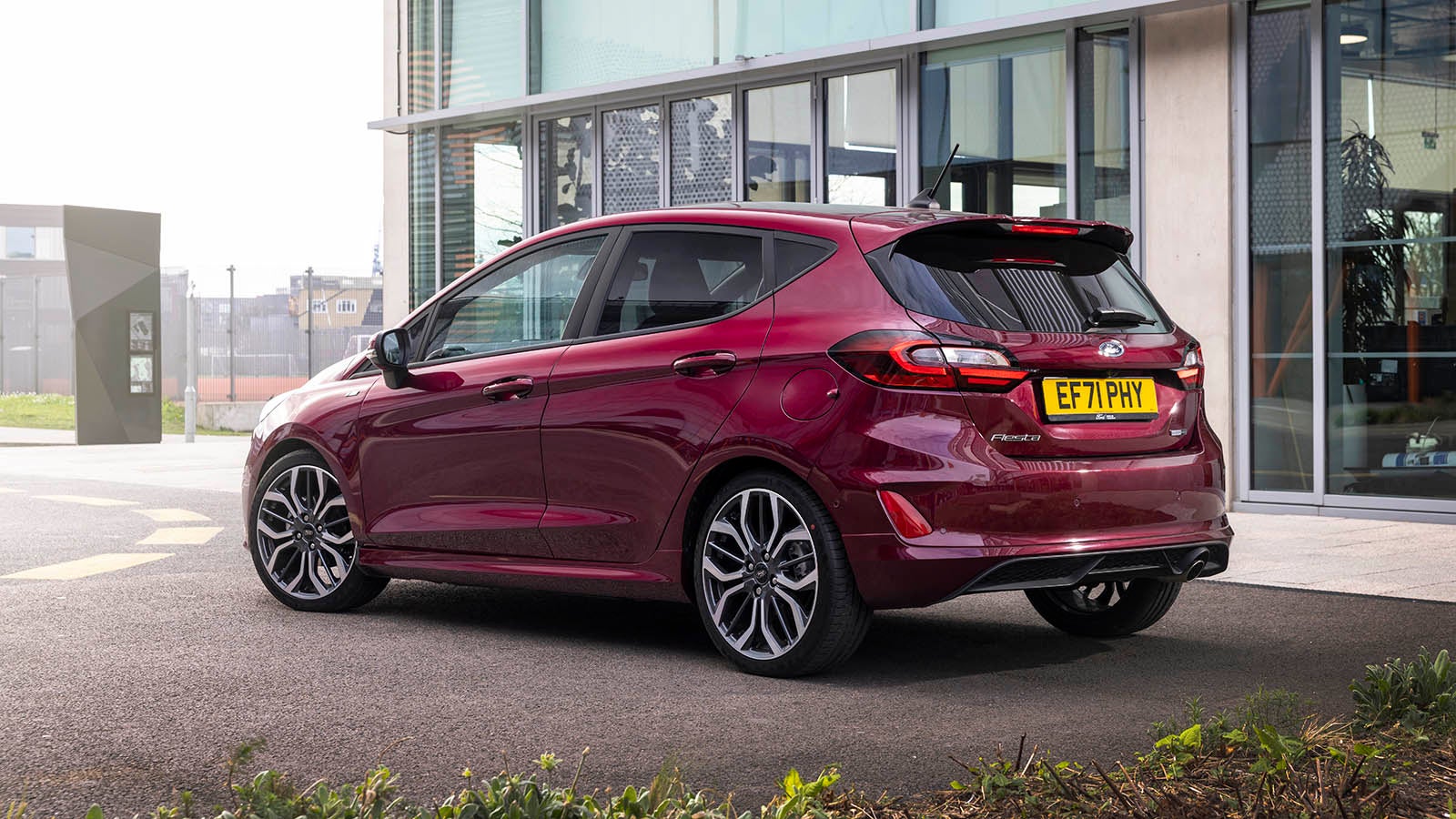 Ford Fiesta in purple, static rear three quarter in city