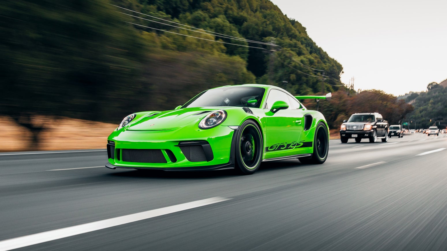 Acid green Porsche 911 GT3 RS driving on US highway