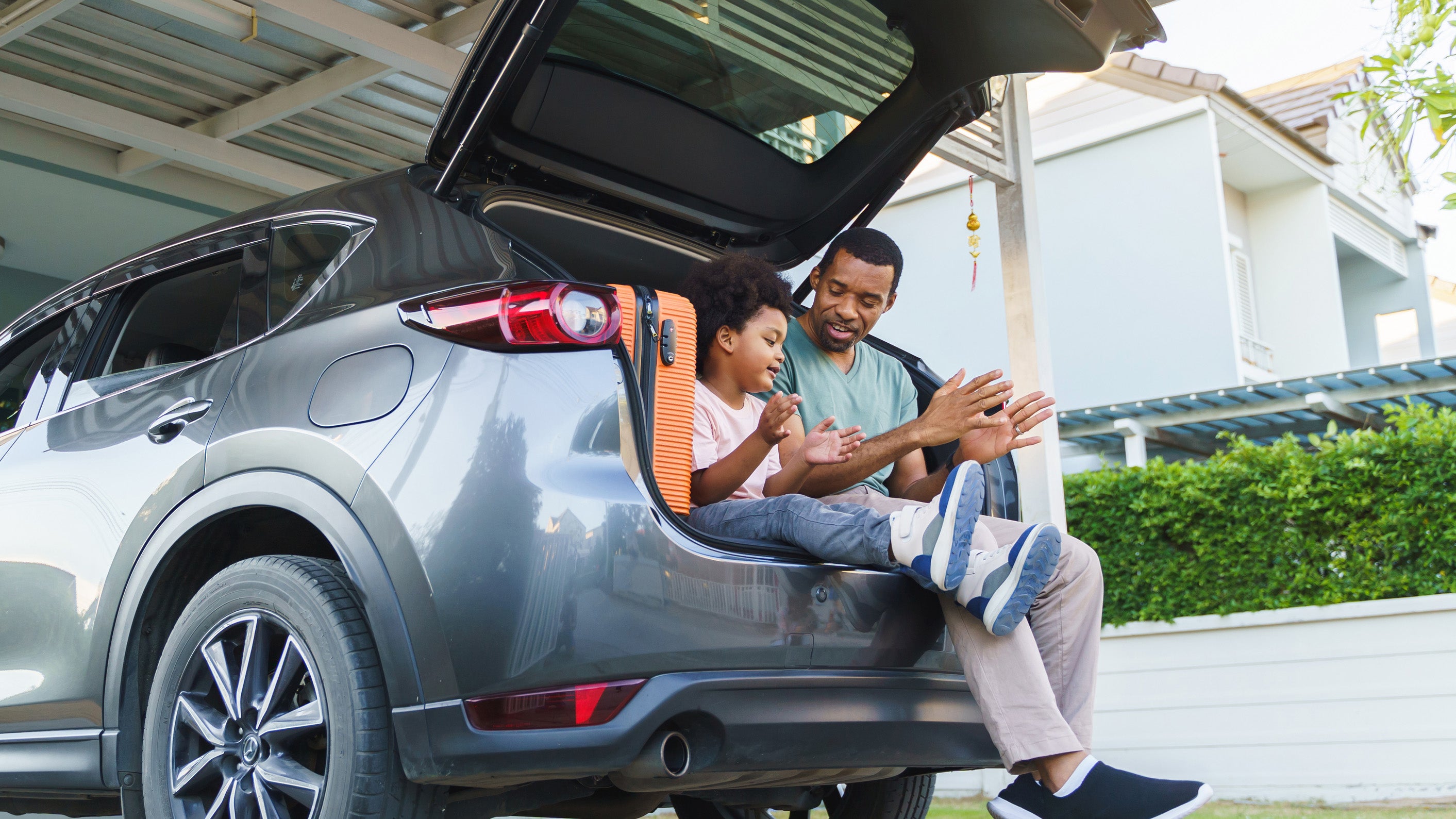 Dad and son playing in car boot